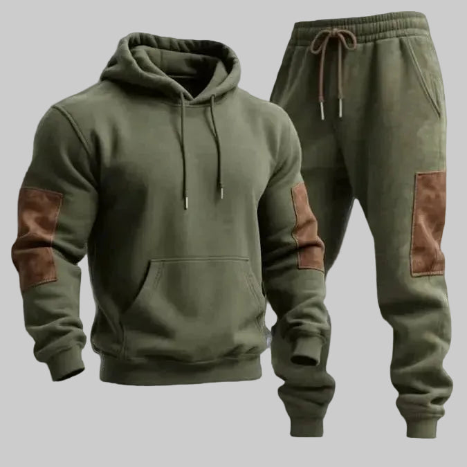 Green hoodie and jogger pants with brown patches on a light blue background